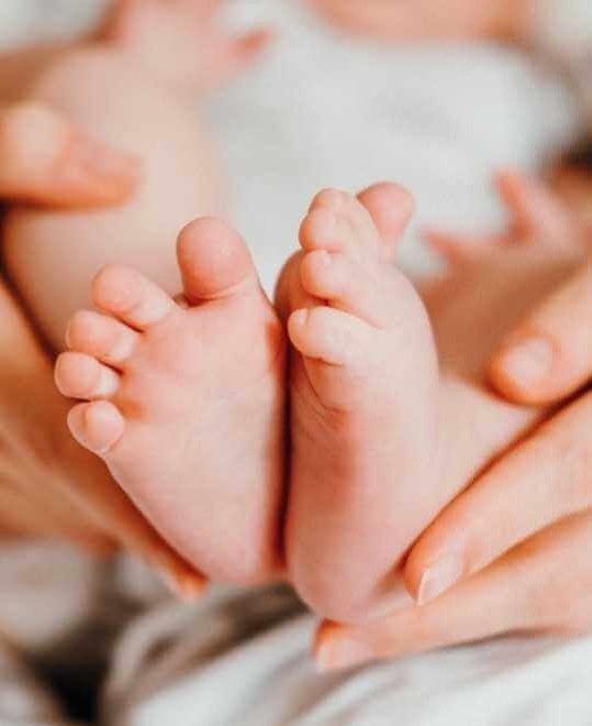 Parent holding the bottom of a child's foot