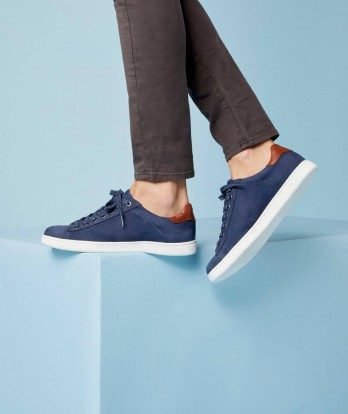 Navy blue suede men's shoes on a blue box