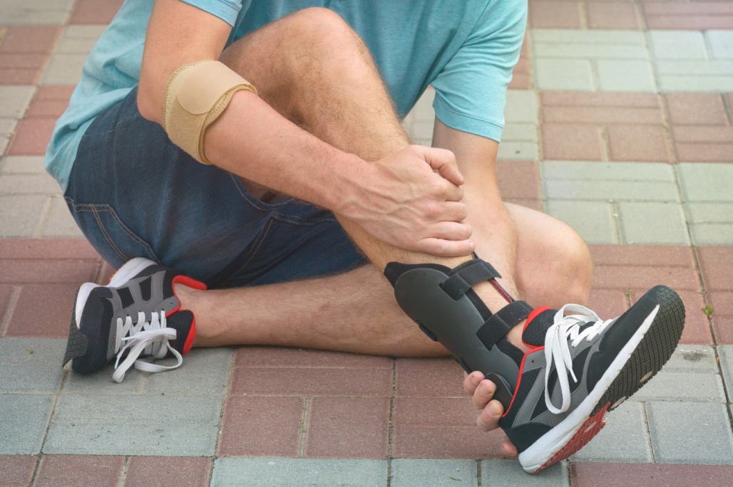 Two hands holding two green custom foot orthotics