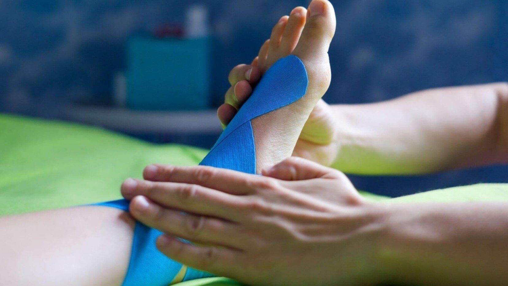 A close up of a blue goved hand placing a thin needle into the skin as part of a dry needling session