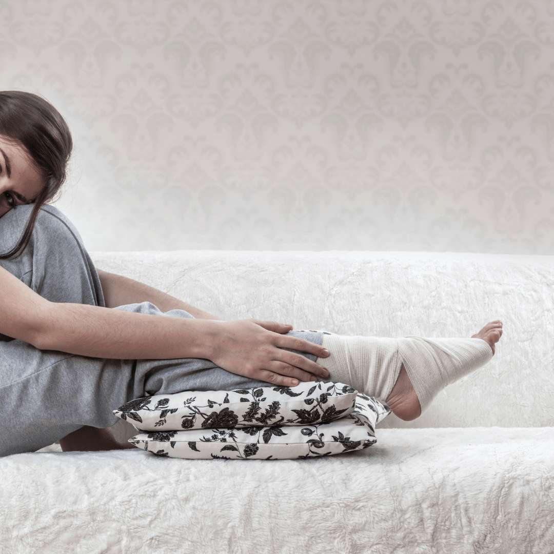 Raise your legs A girl with an injured foot has it elevated on a cushion to reduce swelling