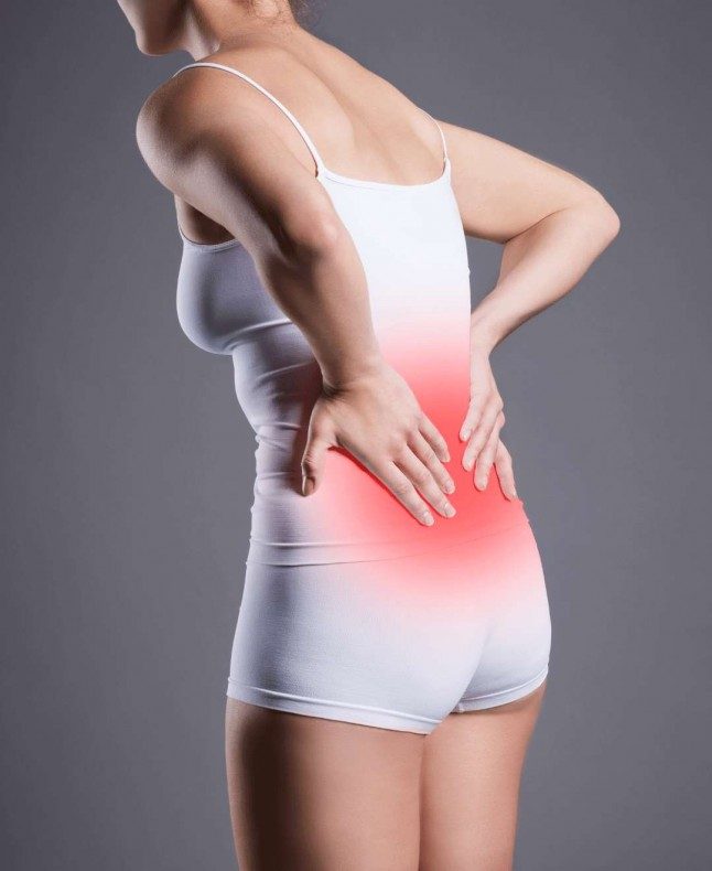 Woman holding her back in pain from sciatica