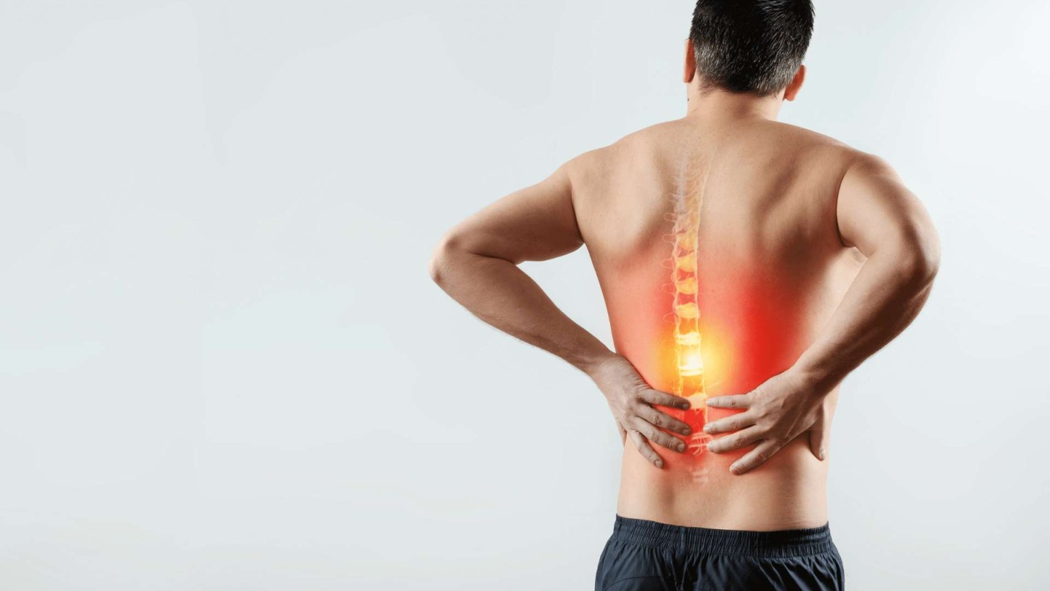 The back of a shirtless man holding his back in pain. His spinal cord is showing through his skin and is highlighted red and yellow signifying pain.